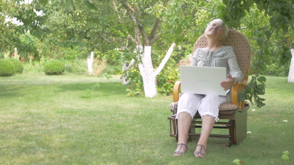 Elderly Woman Sitting In a Rocking Chair.