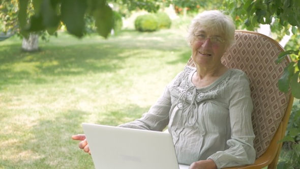 An Elderly Woman Showing Thumbs Up To The Camera.