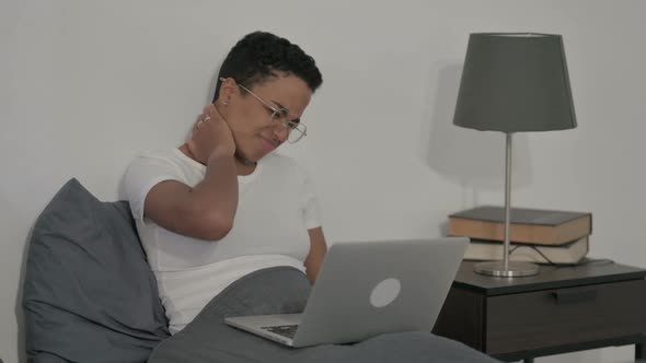 African Woman Having Neck Pain While Using Laptop in Bed