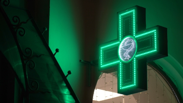 Iluminated Green Pharmaceutical Cross. Pharmacy Street Sign