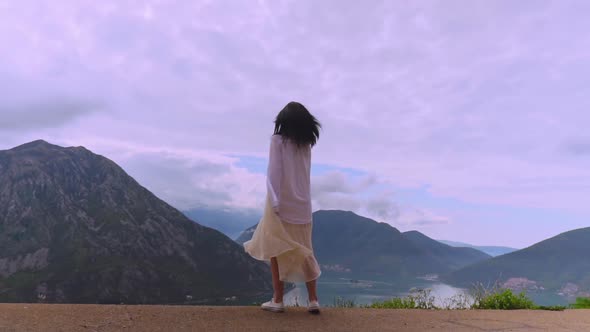 Female in White Clothes Posing on the Hill