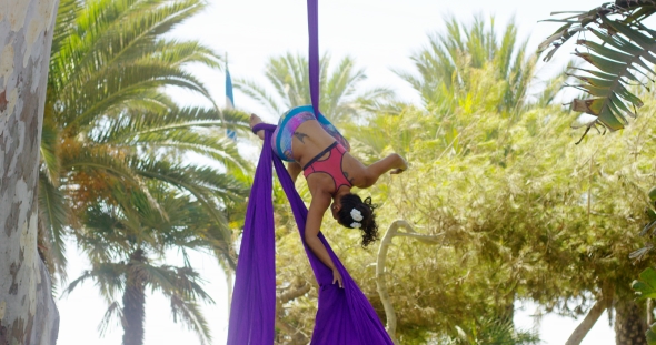 Female Acrobat Working Outdoors On Silk Ribbons
