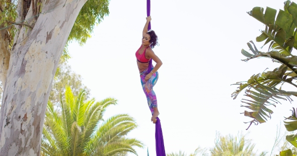 Exotic Acrobatic Dancer Working Out On Silk Ribbon