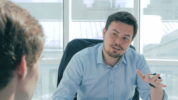 Director Discuss Project With Employee In New Modern Office.