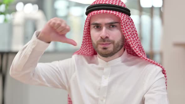 Disappointed Young Arab Businessman Doing Thumbs Down