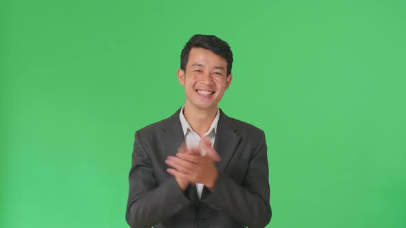 Young Asian Business Man Clapping Her Hands In The Green Screen Studio