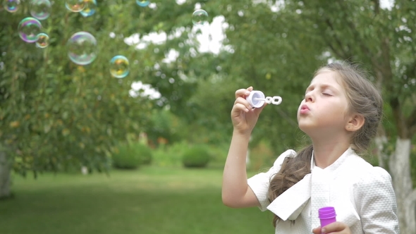 The Girl Blows a Bubbles In The Garden