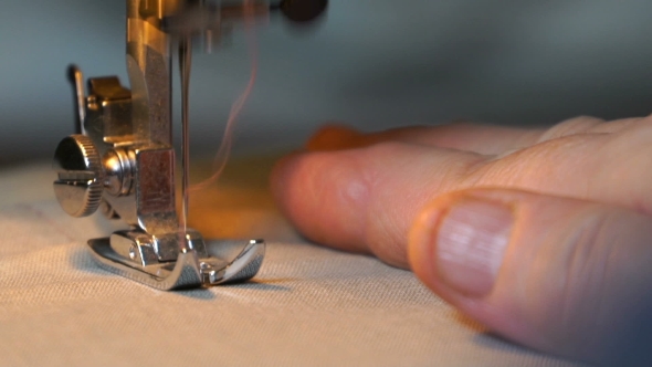 Footage Of Woman Sews On The Sewing Machine.