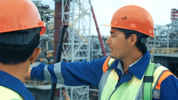 Middle Age Male Engineers Discussing The Project At The Construction Site