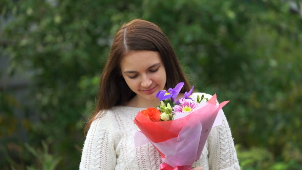 Footage Woman Holding a Bouquet Of Flowers Outdoors.
