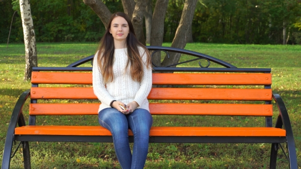 Woman Sitting On a Park Bench