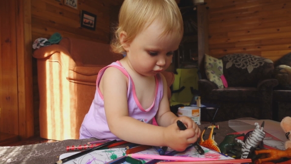 Sweet Little Girl Draws With Colored Pencils