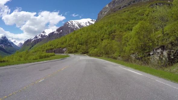 Driving a Car On a Serpentine Road In Norway