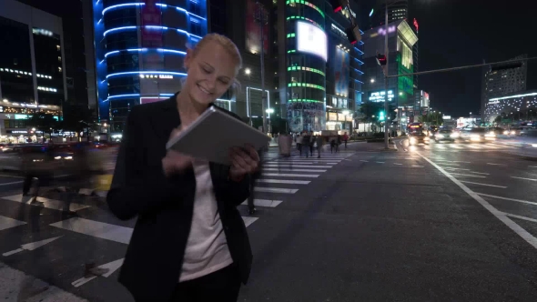 Woman With Tablet PC In Night Seoul, South Korea