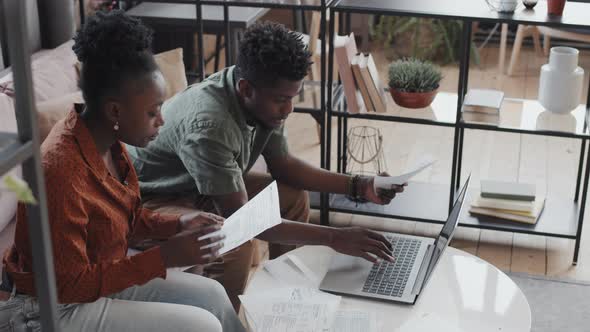 Spouses Doing Paperwork in Living Room