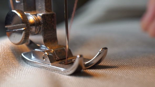 Footage Of Woman Sews On The Sewing Machine.