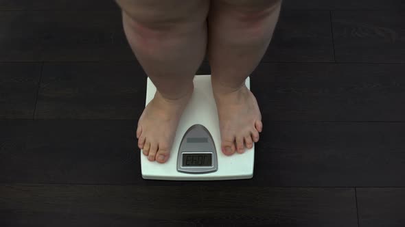 Fat Man Measuring Weight on Scales at Home, Obesity Problem, Sedentary Life