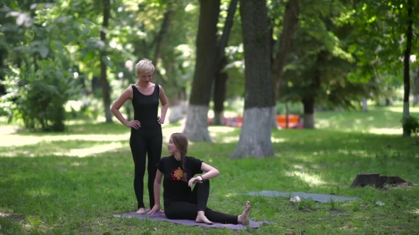 The Girl Follows Directions Her Yoga Instructor.