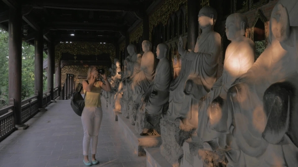Woman Taking Photos Of Statues In Bai Dinh Pagoda, Vietnam