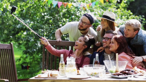 Friends Taking Selfie At Party In Summer Garden