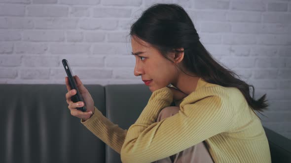 Woman Using Smartphone at Home