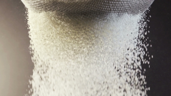 Flour Falling Through a Metal Sieve