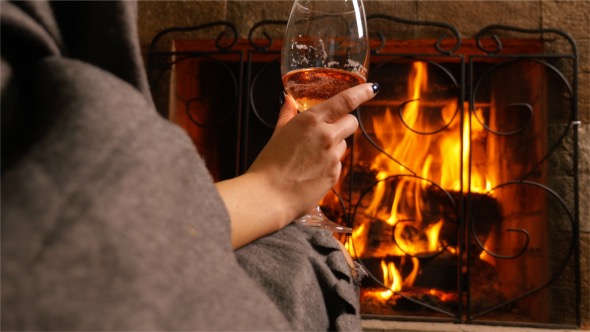 Sip of Wine in Front of a Fireplace
