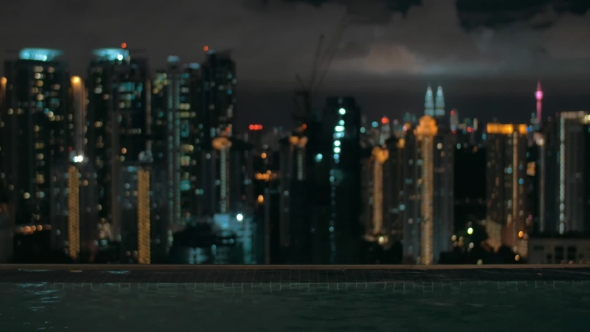 Night View Of Wave On Water On Foreground And City Landscape. Kuala Lumpur, Malaysia