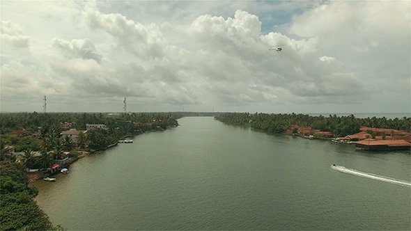 Helicopter Flying Over River Town