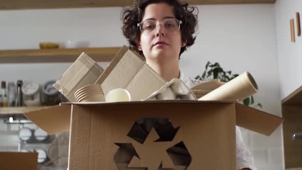 Recycling And Sorting Raw Materials Of Reusable Products Girl Holding A Box Box With Sorted Material
