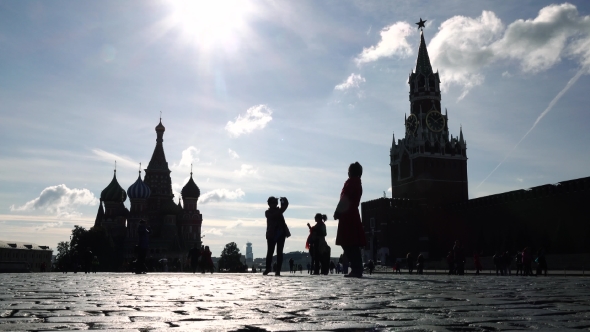Silhouettes Of Tourists Visiting Moscow Kremlin, Red Square And Saint Basil's Cathedral
