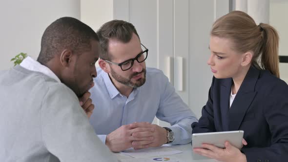 Professional Male and Female Business People Talking in Office