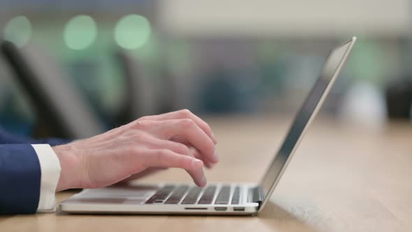 Close Up of Hands of Businessman Typing on Laptop