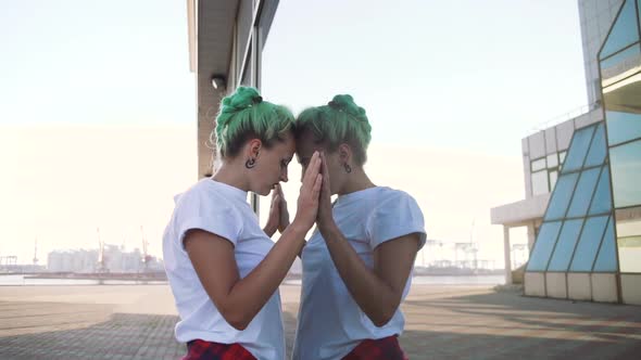 Attractive Young Woman in a Stylish Look and Green Hair Dancing Freely on Urban Background Slow