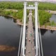 A Man Walks on a Rope Stretched Between the Supports of the Bridge at High Altitude. - VideoHive Item for Sale