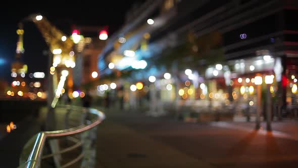 Group of joggers on city street at night, defocused