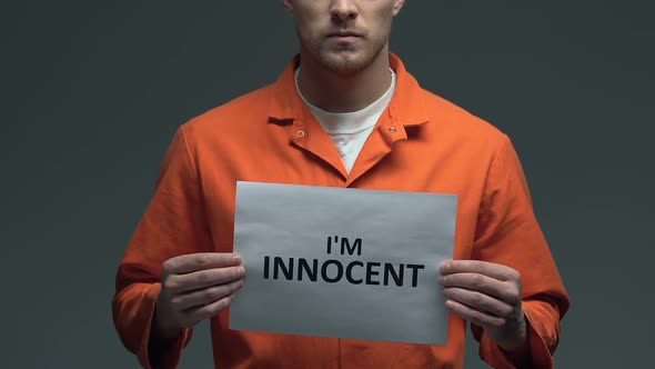 Im Innocent Phrase on Card in Hands of Caucasian Prisoner Criminal Injustice