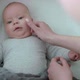 Mother Hands Caresses Baby Boy in Bed Who Smiling at Camera - VideoHive Item for Sale