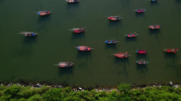 Many fishing boats on the coast beside the mountains, beautiful sea area in Thailand.