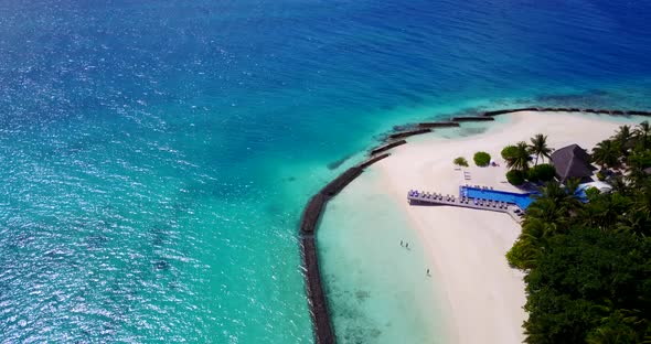 Daytime overhead island view of a sandy white paradise beach and aqua blue water background in hi re