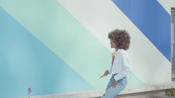 Beautiful young woman with curly hairstyle and fashionable clothes