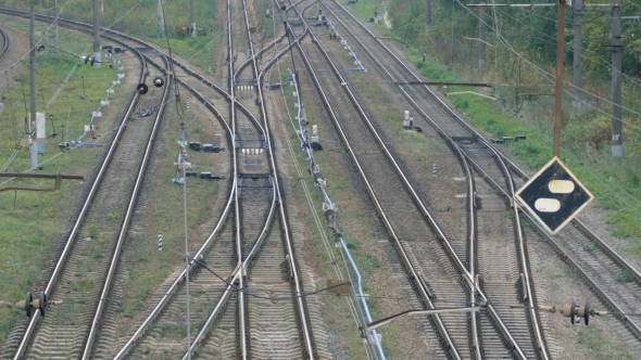 Empty Railroad Track With Some Train Switches and Electrical Wires Leading Off Into the Distance