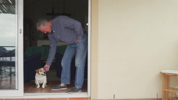 Senior man with his dog at home