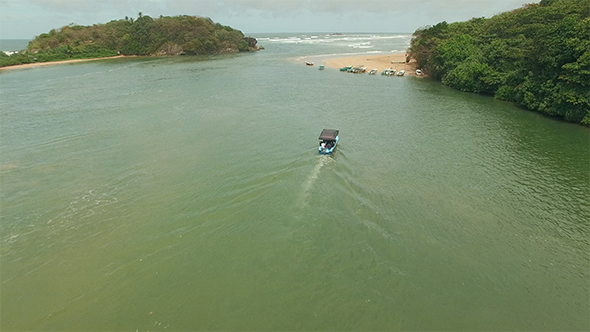 Flyover Motor Boat Approaching a River Mouth