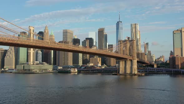 An aerial view from the Brooklyn side of the East River on a beautiful morning. The camera dolly in