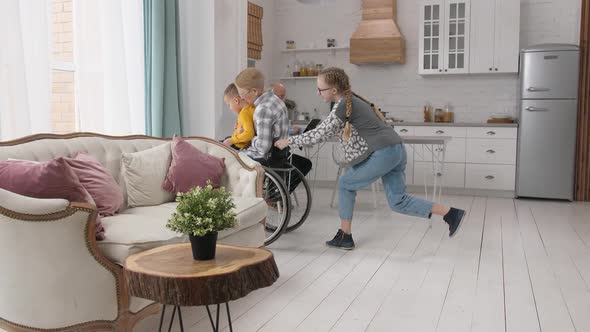 Girl Riding Wheelchair with Grandma and Brother