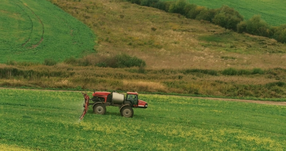 Tractor In a Field Of Rapeseed Processing