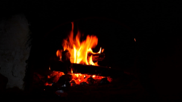 Fire Is Burning In a Rustic Wood Stove