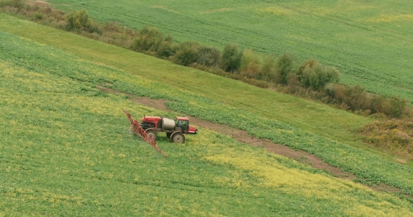 Aerial Shots . Farm Tractor Spray Autumn Crop Field