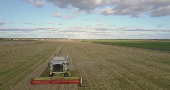 Aerial Motion Over Operating Thresher at Peak of Harvesting